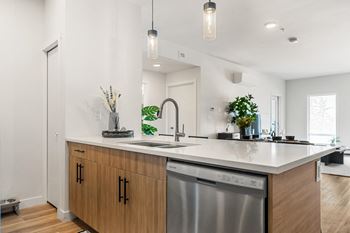 a kitchen with an island and a stainless steel dishwasher